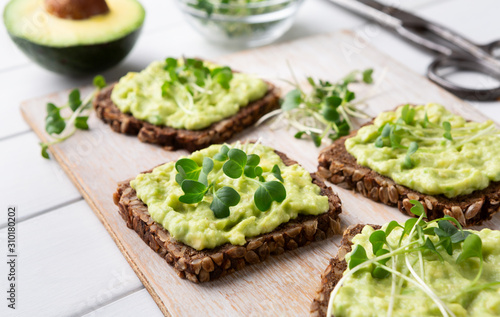 Fresh wholegrain toasts with avocado and microgreens