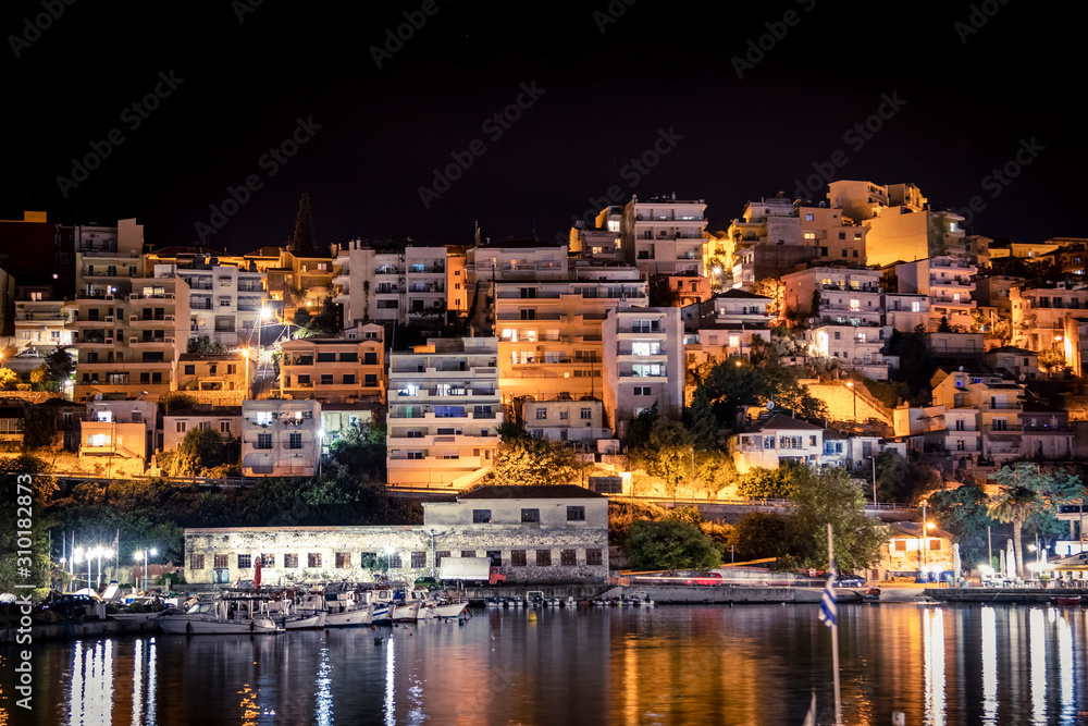 Residential houses on the seashore near the bay with boats. Greece.