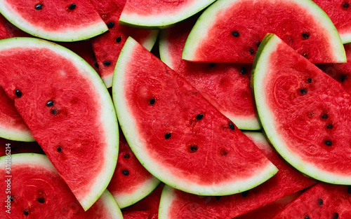 A large number of cut slices of watermelon photo