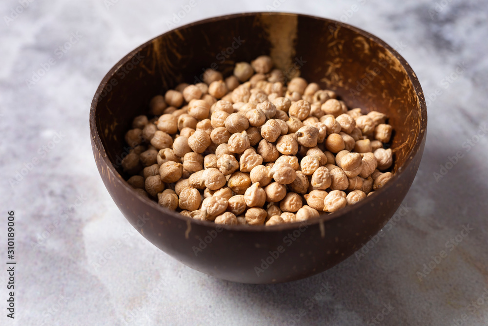 Vegetarian food. chickpeas in an organic bowl made of natural material on a gray background. Vegetarian food. chickpeas in an organic bowl made of natural material on a gray background.