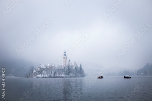 Tourism boats to the island in lake Bled in winter © LAMushom