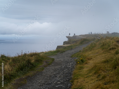 Tourists on cliff, Cliffs of Moher, Lahinch, County Clare, Ireland photo