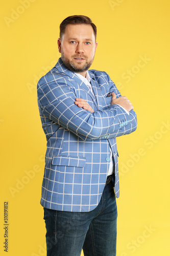 Portrait of mature man on yellow background