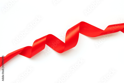 Red curly ribbon isolated on white background. Valentines day or birthday celebration concept. Top view