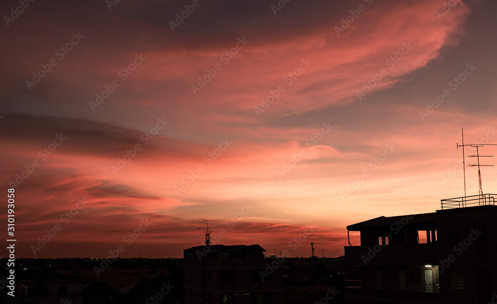 Colorful the sky and dark clouds with silhouette of building and residential. During the evening into night. Colorful the sky and dark clouds with silhouette of building and residential. During the evening into night.