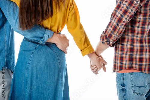 cropped view of couple hugging while woman holding hands with another man isolated on white