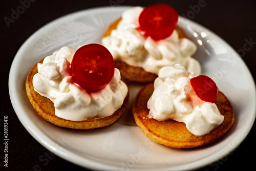 3 pancakes with cottage cheese and tomato.