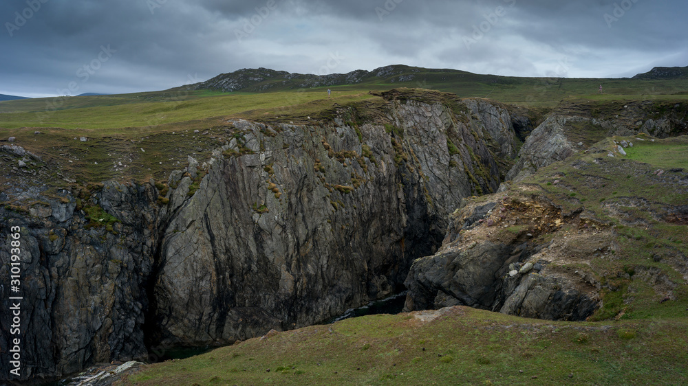 Person standing near cliff, Achill Island, County Mayo, Ireland