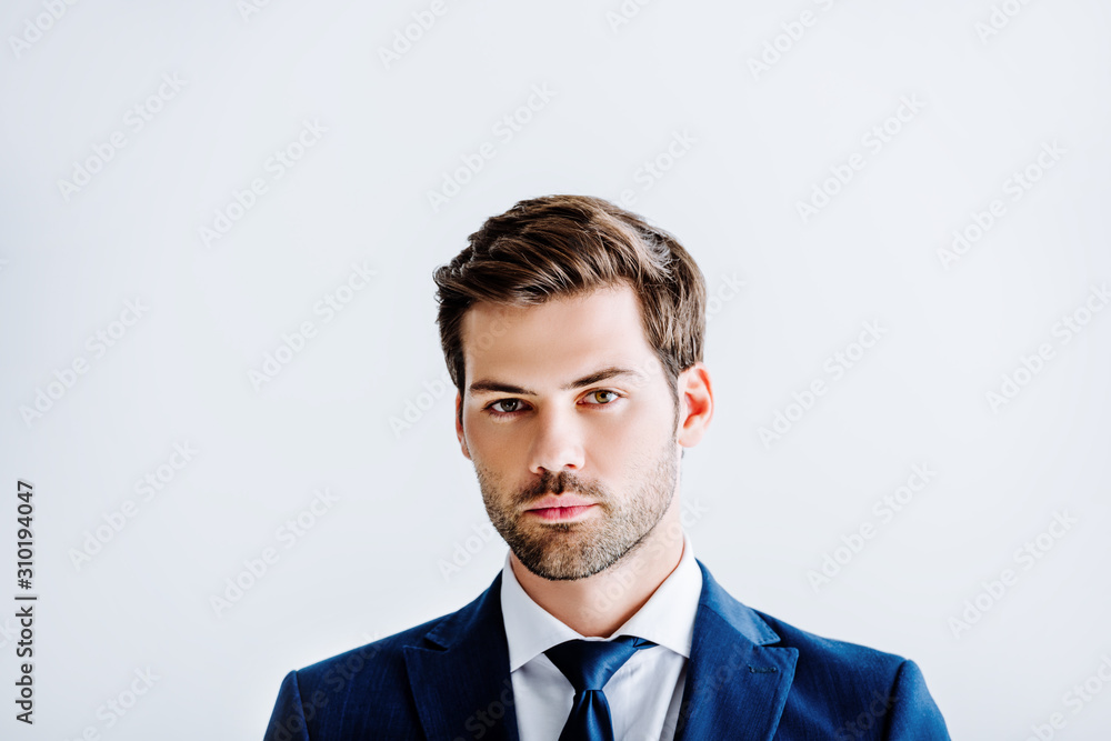 handsome businessman in blue suit looking at camera isolated on white handsome businessman in blue suit looking at camera isolated on white