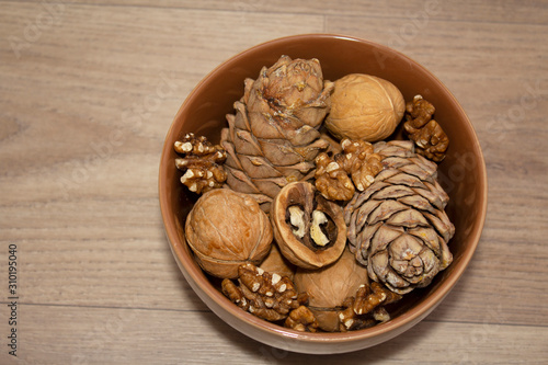  different nuts in a cup on a wooden background