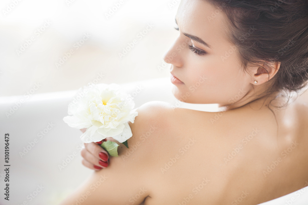 Perfect woman bathing with flowers and milk Perfect woman bathing with flowers and milk