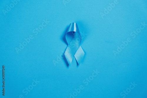 Symbol for support men. Blue ribbon on blue background . Healthcare, International men, Father and World cancer day concept. Flat lay, copy space photo