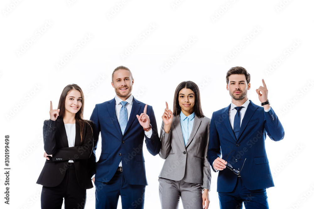 multicultural business people in suits pointing with fingers up isolated on white multicultural business people in suits pointing with fingers up isolated on white