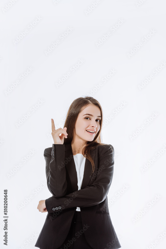 smiling confident businesswoman in suit pointing with finger up isolated on white smiling confident businesswoman in suit pointing with finger up isolated on white