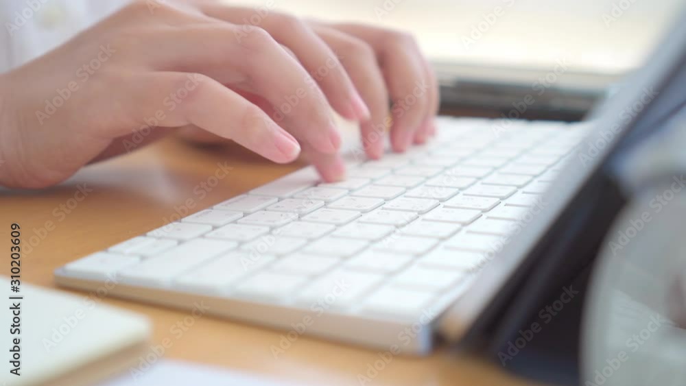 Young Freelancer or Businessman working at home office and typing on keyboard smartphone tablet. Working Online Or Studying And Learning While Using smartphone tablet. Freelance Work, Business concept Young Freelancer or Businessman working at home office and typing on keyboard smartphone tablet. Working Online Or Studying And Learning While Using smartphone tablet. Freelance Work, Business concept