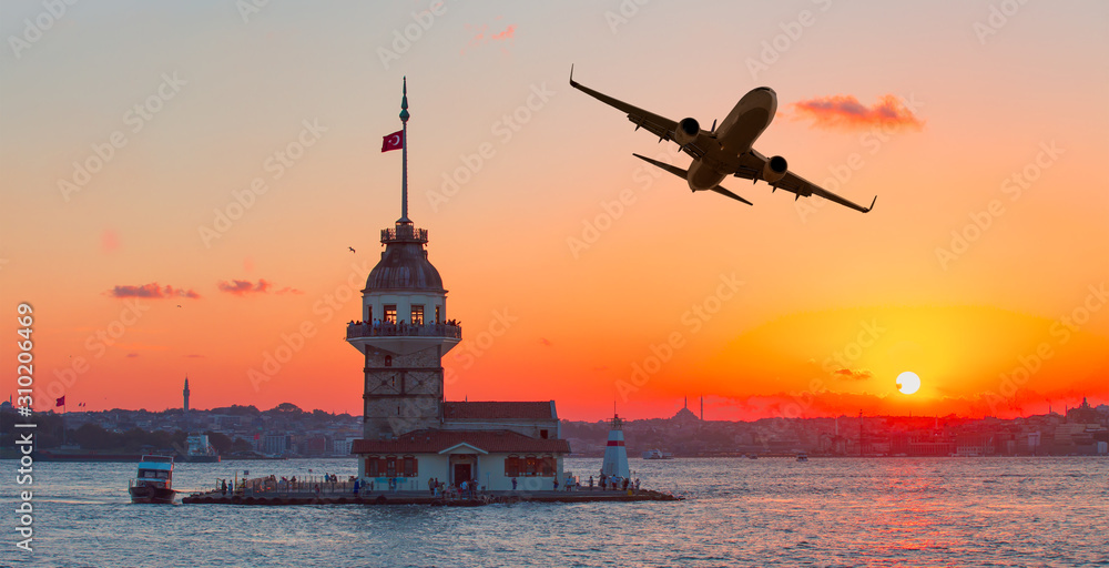 Passenger plane flying over the sea bosphorus Istanbul, Turkey , Maiden Tower