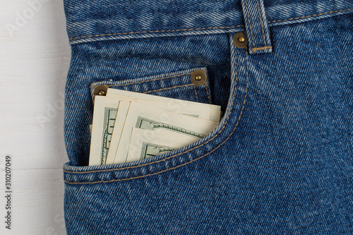 A few hundred dollars banknotes in a jeans pocket. The concept of wealth and salary for work.