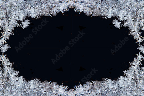 Slika na platnu Decorative ice crystals on a window in form of a frame on black matte background