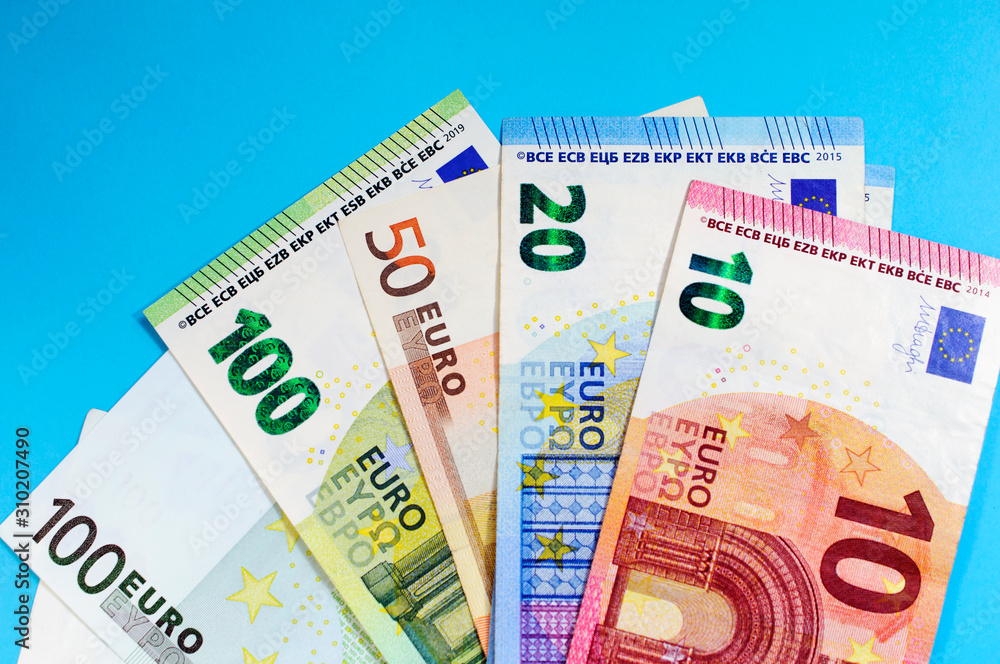 Money euro banknotes on a blue background, top view Money euro banknotes on a blue background, top view