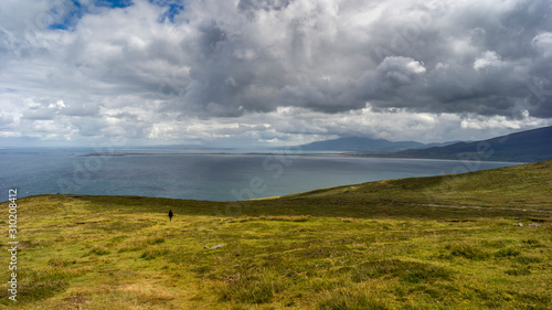 Hiker seen on the coastline from Brandon Point, Murirrigane, Brandon, County Kerry, Ireland