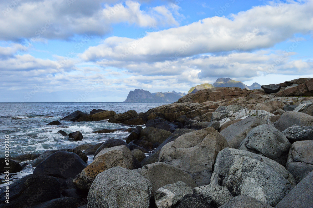 Spectacular view from one of the beaches near Myrland at mountains on Lofoten Islands in Norway Spectacular view from one of the beaches near Myrland at mountains on Lofoten Islands in Norway