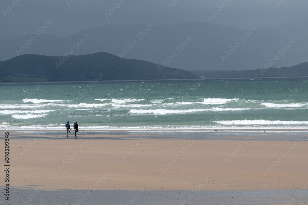 Hikers on beach of beach, Castlegregory, County Kerry, Ireland