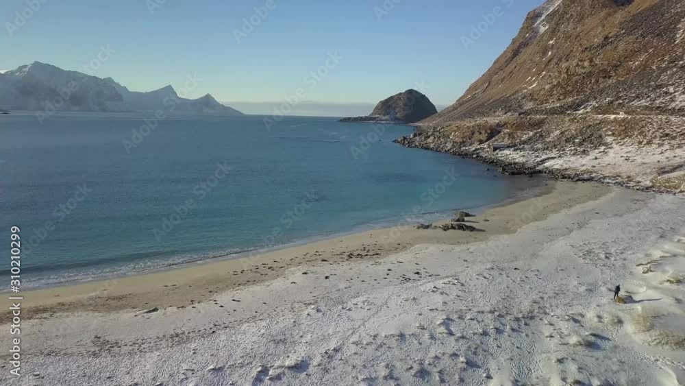 takeoff in drone on a snowy beach in Norway with blue water and a clear sunny sky takeoff in drone on a snowy beach in Norway with blue water and a clear sunny sky