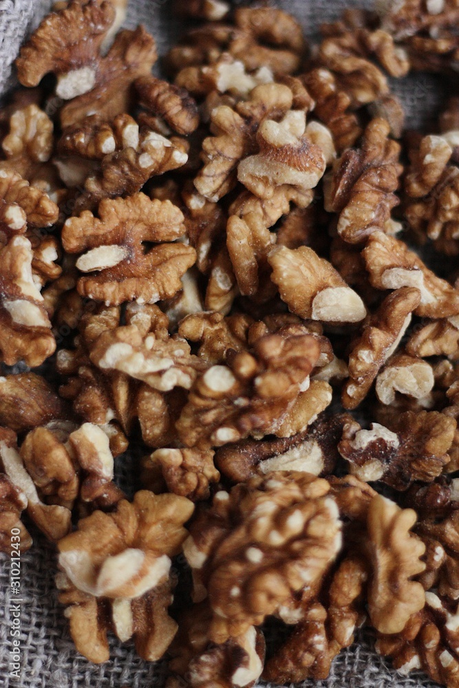 Walnuts on a grey linen background macro Walnuts on a grey linen background macro