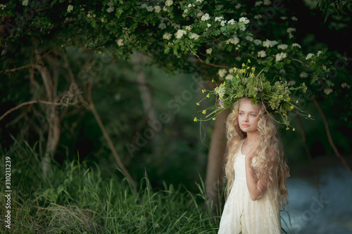 A woman in a white summer dress in a dark forest.