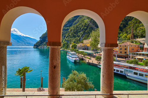 Riva del Garda,Lago di Garda ,Italy - 13 October 2019:Tourists enjoying a walk around Lake Garda, colorful autumn in Riva del Garda surrounded by mountains, Trentino Alto Adige region, Lago di garda, 