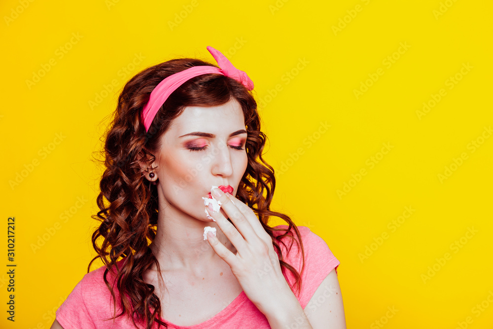 girl in pink dress pinup-style eats cream licks fingers girl in pink dress pinup-style eats cream licks fingers