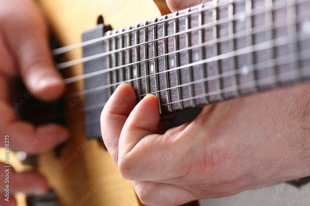 Male arms playing classic shape electric guitar Male arms playing classic shape electric guitar