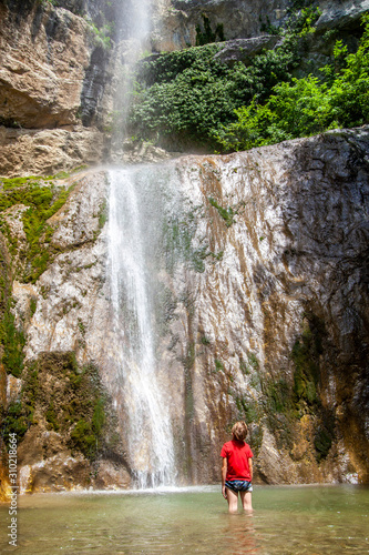 Boy at the waterfall