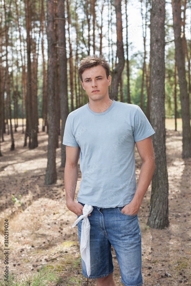 Handsome young man hiking in forest Handsome young man hiking in forest