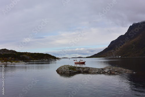 Boat on the water between the mountains © Kelly