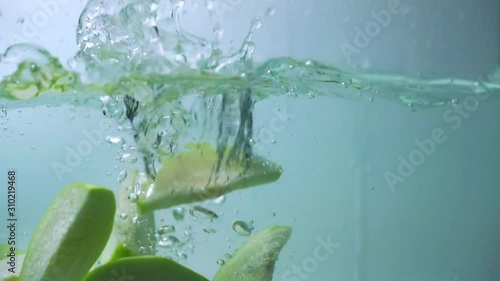 Fresh slice guava fruit fall in water splash background.
