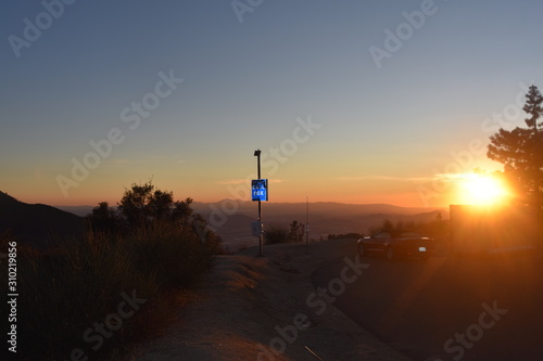 silhouette of man on top of the mountain at sunset