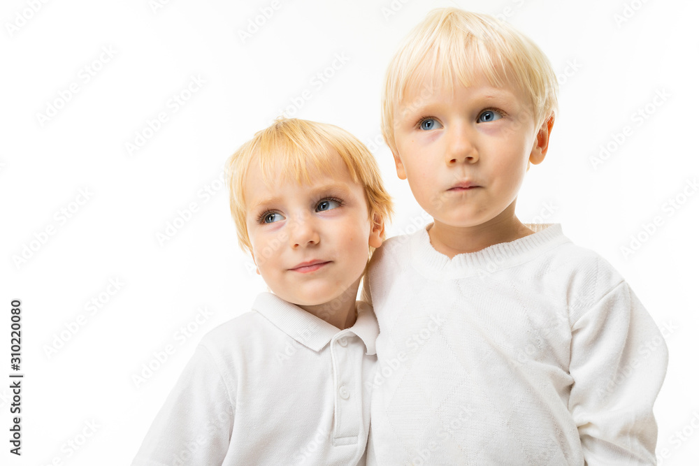 Two little caucasian brothers with blonde and fair red hair smiles, portrait isolated on white background Two little caucasian brothers with blonde and fair red hair smiles, portrait isolated on white background
