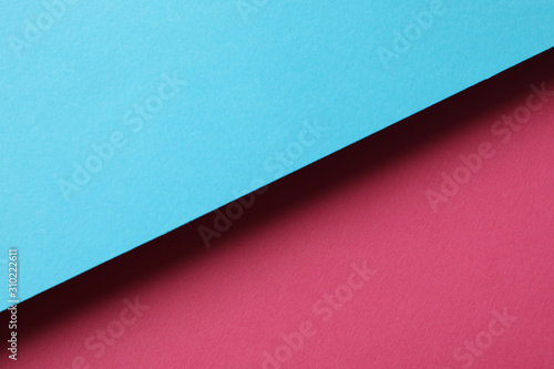 Two tone background made of sheets: blue and pink. Abstract background