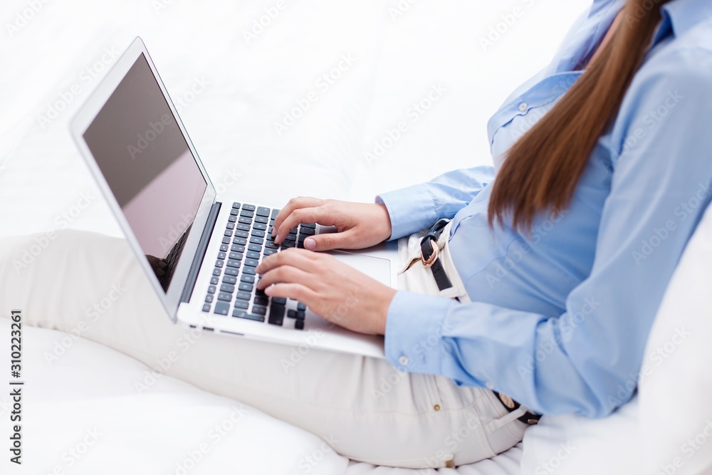 Fototapeta premium Close-up view of hands using laptop