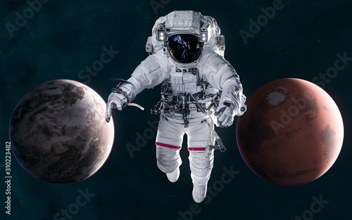 Astronaut on background of Mars and Earth. Solar system. 3D Render. Science fiction. Elements of this image furnished by NASA