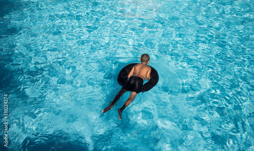 Boy playing in water with lifebuoy On vacation