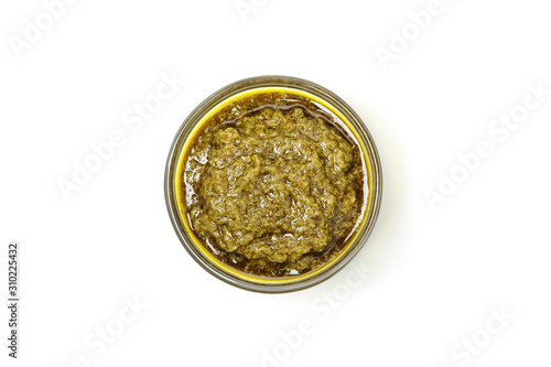 Tasty pesto sauce in bowl isolated on white background