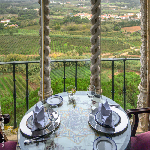 Table setting on the balcony of a house, Obidos, Leiria District, Portugal photo