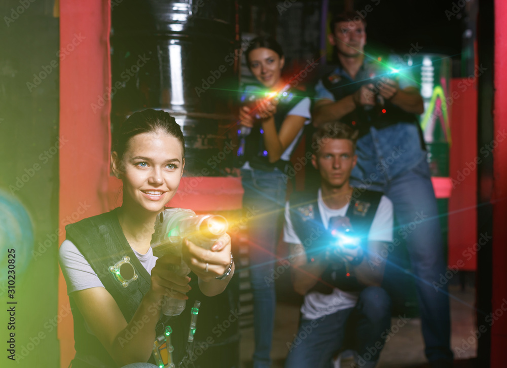 Young girl with laser gun took aim, having fun with friends duri