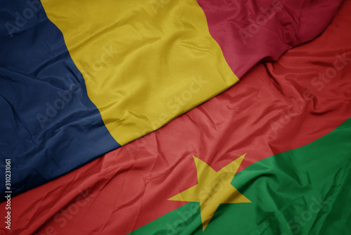 waving colorful flag of burkina faso and national flag of chad.