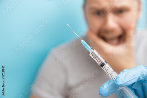 Принти на полотні Man is fear and cries from syringe with vaccination doctor appointment