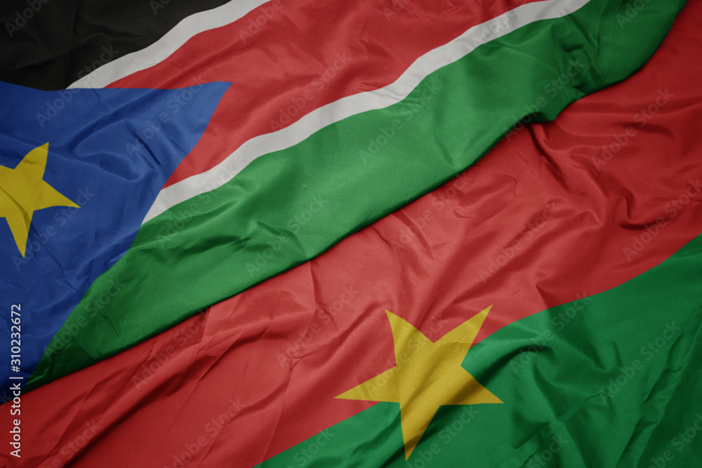 waving colorful flag of burkina faso and national flag of south sudan.