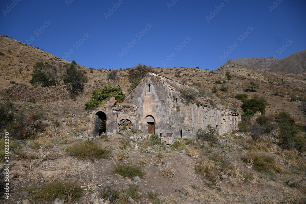 ruined medieval church in Armenia. ruined medieval university. Ancient  university and castle. medieval university on a mountain landscape. medieval university on a background of cloudy sky.