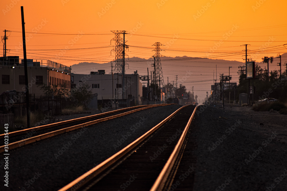 railway tracks lit goldent by sunset